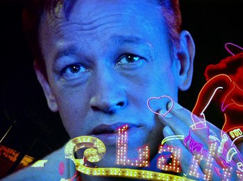 Movie still from “One from the Heart” (1981), directed by Francis Ford Coppola – A man's face in neon lights; Close Up shot, Low angle