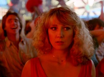 Movie still from “One from the Heart” (1981), directed by Francis Ford Coppola – A woman in a red dress is looking at the camera; Close Up shot, Low angle