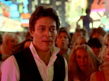 Movie still from “One from the Heart” (1981), directed by Francis Ford Coppola – A man standing in front of a group of people; Close Up shot, Low angle