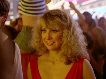 Movie still from “One from the Heart” (1981), directed by Francis Ford Coppola – A woman in a red dress smiling for the camera; Close Up shot, Low angle