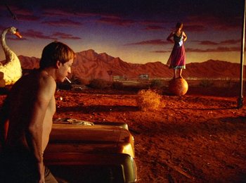 Movie still from “One from the Heart” (1981), directed by Francis Ford Coppola – A man and a woman are standing in a field; Wide shot, Low angle