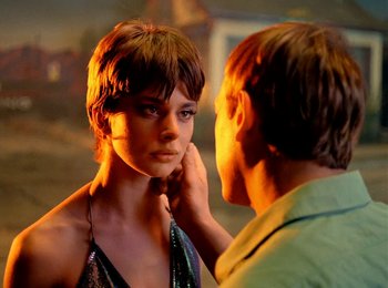 Movie still from “One from the Heart” (1981), directed by Francis Ford Coppola – A man touching the face of a young woman; Close Up shot, Over the shoulder angle