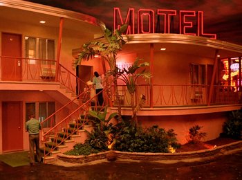 Movie still from “One from the Heart” (1981), directed by Francis Ford Coppola – Two people are walking up the stairs of a motel; Extreme Wide shot, High angle