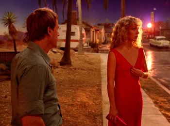 Movie still from “One from the Heart” (1981), directed by Francis Ford Coppola – A man and a woman standing next to each other on a sidewalk; Wide shot, Over the shoulder angle