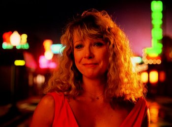 Movie still from “One from the Heart” (1981), directed by Francis Ford Coppola – A woman in a red dress standing in front of neon lights; Close Up shot, Low angle