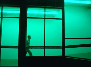Movie still from “One from the Heart” (1981), directed by Francis Ford Coppola – A person standing in front of a large window; Wide shot, Low angle