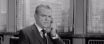 Movie still from “One, Two, Three” (1961), directed by Billy Wilder – An old photo of a man on the phone; Close Up shot, Low angle