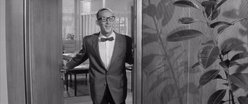 Movie still from “One, Two, Three” (1961), directed by Billy Wilder – A black and white photo of a man in a suit and bow tie; Medium shot, Low angle