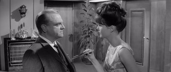 Movie still from “One, Two, Three” (1961), directed by Billy Wilder – An old photo of a man and a woman; Medium shot, Over the shoulder angle