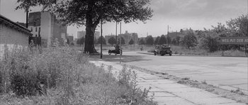 Movie still from “One, Two, Three” (1961), directed by Billy Wilder – An old photo of cars driving down the street; Extreme Wide shot, High angle