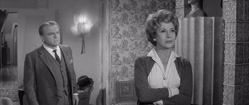 Movie still from “One, Two, Three” (1961), directed by Billy Wilder – An older woman standing in front of a wall; Medium shot, Over the shoulder angle