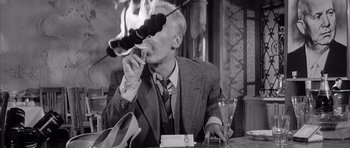 Movie still from “One, Two, Three” (1961), directed by Billy Wilder – An older man sitting at a table in a restaurant; Medium shot, Low angle