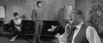 Movie still from “One, Two, Three” (1961), directed by Billy Wilder – A man and a woman are standing in a living room; Medium shot, Low angle