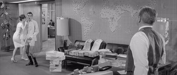Movie still from “One, Two, Three” (1961), directed by Billy Wilder – A living room filled with lots of boxes and a couch; Wide shot, High angle