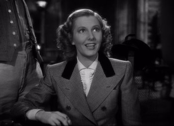 Movie still from “Only Angels Have Wings” (1939), directed by Howard Hawks – An old photo of a woman wearing a suit; Close Up shot, Low angle