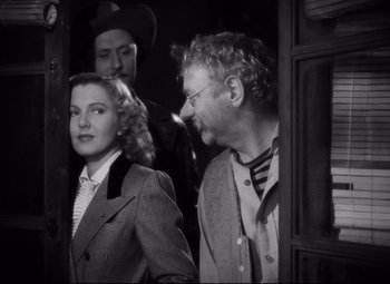 Movie still from “Only Angels Have Wings” (1939), directed by Howard Hawks – A black and white photo of a man and a woman; Medium shot, Over the shoulder angle