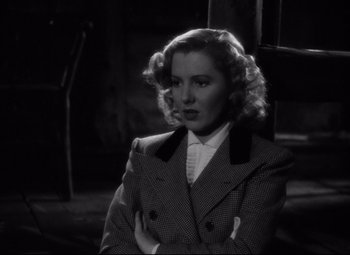 Movie still from “Only Angels Have Wings” (1939), directed by Howard Hawks – A black - and - white photo of a woman in a suit; Close Up shot, Over the shoulder angle