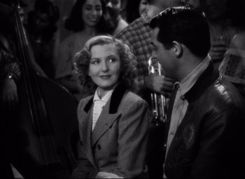 Movie still from “Only Angels Have Wings” (1939), directed by Howard Hawks – A man and a woman are sitting in front of each other; Medium shot, High angle