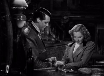 Movie still from “Only Angels Have Wings” (1939), directed by Howard Hawks – A man and a woman sitting at a table; Medium shot, High angle