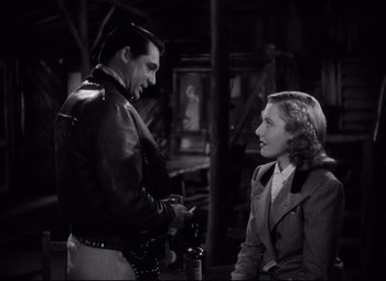 Movie still from “Only Angels Have Wings” (1939), directed by Howard Hawks – A man and a woman talking to each other; Medium shot, Over the shoulder angle