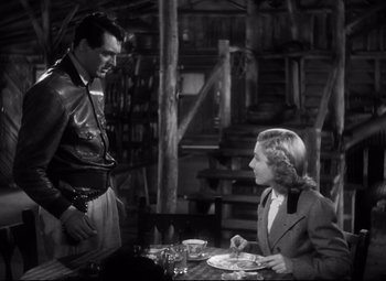 Movie still from “Only Angels Have Wings” (1939), directed by Howard Hawks – A man and a woman sitting at a dinner table; Medium shot, Over the shoulder angle