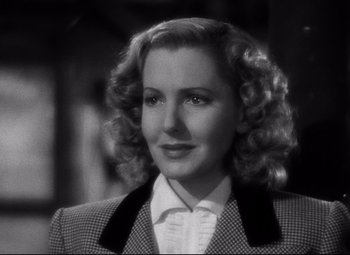 Movie still from “Only Angels Have Wings” (1939), directed by Howard Hawks – A black - and - white photo of a woman with curly hair; Close Up shot, Over the shoulder angle