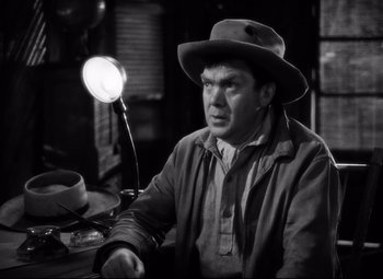 Movie still from “Only Angels Have Wings” (1939), directed by Howard Hawks – A black and white photo of a man sitting on a motorcycle; Medium shot, Low angle