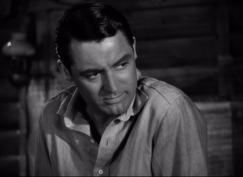 Movie still from “Only Angels Have Wings” (1939), directed by Howard Hawks – A black - and - white photo of a man in a dress shirt; Close Up shot, Low angle