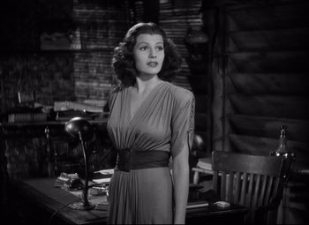 Movie still from “Only Angels Have Wings” (1939), directed by Howard Hawks – A black and white photo of a woman in a dress; Medium shot, Over the shoulder angle