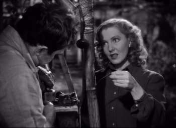 Movie still from “Only Angels Have Wings” (1939), directed by Howard Hawks – A man and a woman talking to each other in front of a bamboo pole; Close Up shot, Over the shoulder angle