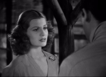 Movie still from “Only Angels Have Wings” (1939), directed by Howard Hawks – An old photo of a man and a woman; Close Up shot, Over the shoulder angle