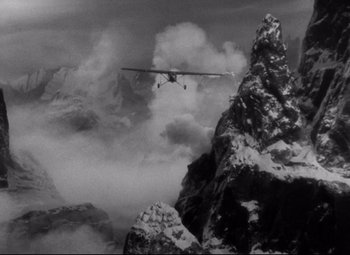 Movie still from “Only Angels Have Wings” (1939), directed by Howard Hawks – An airplane is flying over a snowy mountain top; Extreme Wide shot, High angle