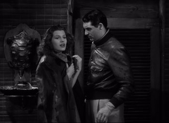 Movie still from “Only Angels Have Wings” (1939), directed by Howard Hawks – A man and a woman standing next to each other; Medium shot, Low angle