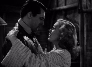 Movie still from “Only Angels Have Wings” (1939), directed by Howard Hawks – A man and a woman embracing each other in a black and white photo; Close Up shot, Low angle