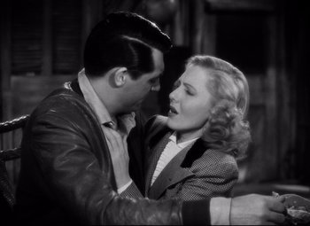 Movie still from “Only Angels Have Wings” (1939), directed by Howard Hawks – A man and a woman kissing each other; Close Up shot, Low angle