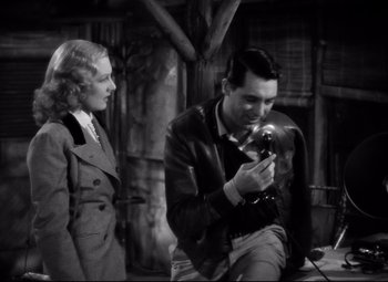 Movie still from “Only Angels Have Wings” (1939), directed by Howard Hawks – A man and a woman looking at something on a camera; Medium shot, High angle