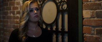 Movie still from “Only the Brave” (2017), directed by Joseph Kosinski – A beautiful young lady standing in front of an iron gate; Close Up shot, Over the shoulder angle