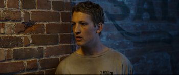 Movie still from “Only the Brave” (2017), directed by Joseph Kosinski – A young man standing in front of a brick wall; Close Up shot, High angle
