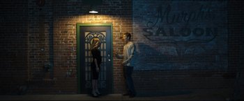 Movie still from “Only the Brave” (2017), directed by Joseph Kosinski – A man and a woman standing in front of a door; Wide shot, Low angle