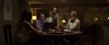 Movie still from “Only the Brave” (2017), directed by Joseph Kosinski – A group of people sitting around a table with a computer; Medium shot, Low angle