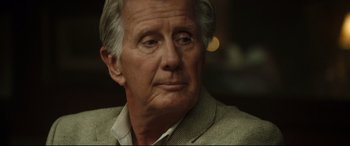 Movie still from “Only the Brave” (2017), directed by Joseph Kosinski – An older man in a jacket looking at the camera; Close Up shot, Over the shoulder angle