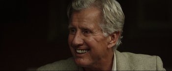 Movie still from “Only the Brave” (2017), directed by Joseph Kosinski – An older man with grey hair smiling for the camera; Close Up shot, Over the shoulder angle
