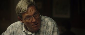 Movie still from “Only the Brave” (2017), directed by Joseph Kosinski – An older man wearing glasses and a checkered shirt; Close Up shot, Over the shoulder angle