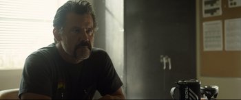 Movie still from “Only the Brave” (2017), directed by Joseph Kosinski – A person sitting in a room near a window; Close Up shot, Over the shoulder angle