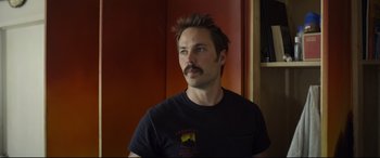 Movie still from “Only the Brave” (2017), directed by Joseph Kosinski – A person with a beard and a mustache; Close Up shot, Over the shoulder angle