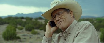 Movie still from “Only the Brave” (2017), directed by Joseph Kosinski – A man wearing a cowboy hat talking on a cell phone; Close Up shot, Low angle