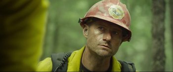 Movie still from “Only the Brave” (2017), directed by Joseph Kosinski – A person wearing a hard hat; Close Up shot, Low angle