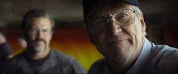 Movie still from “Only the Brave” (2017), directed by Joseph Kosinski – An older man wearing glasses and a hat; Close Up shot, Low angle
