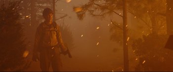 Movie still from “Only the Brave” (2017), directed by Joseph Kosinski – A man standing in a field holding a gun; Wide shot, Low angle