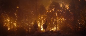 Movie still from “Only the Brave” (2017), directed by Joseph Kosinski – A couple of people that are standing in the woods; Extreme Wide shot, Low angle